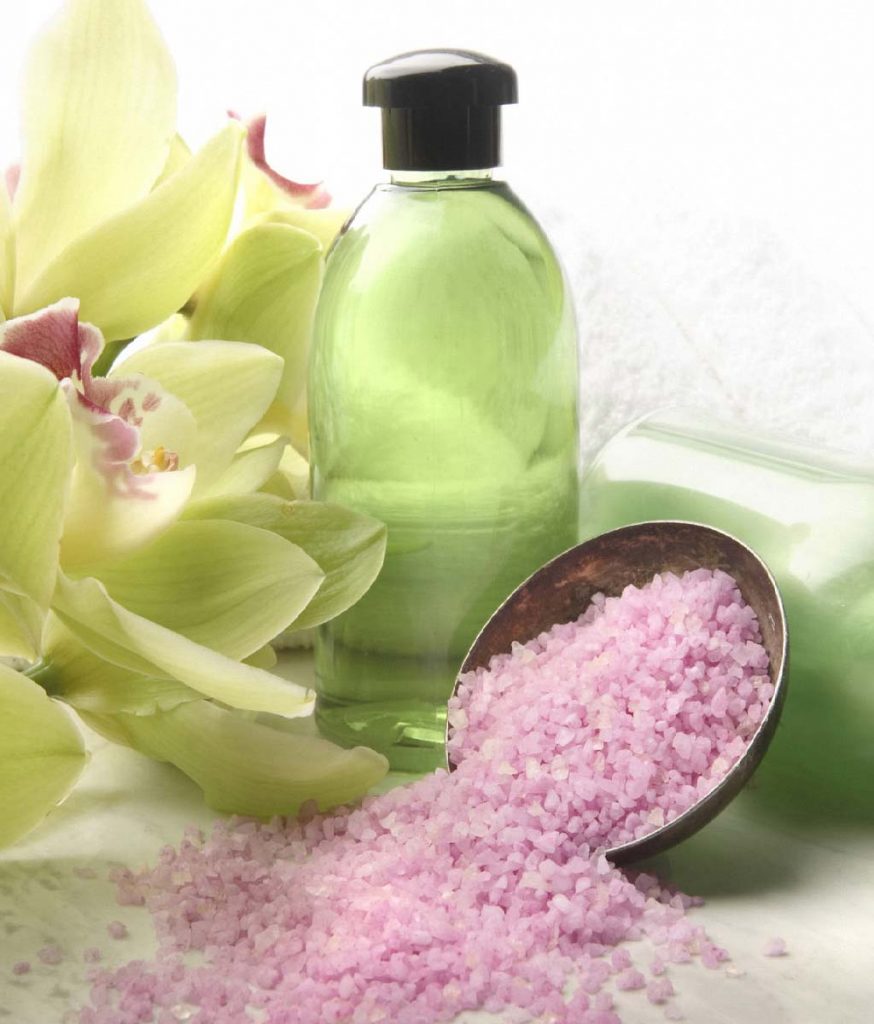 green bottle with yellow flowers and pink salt