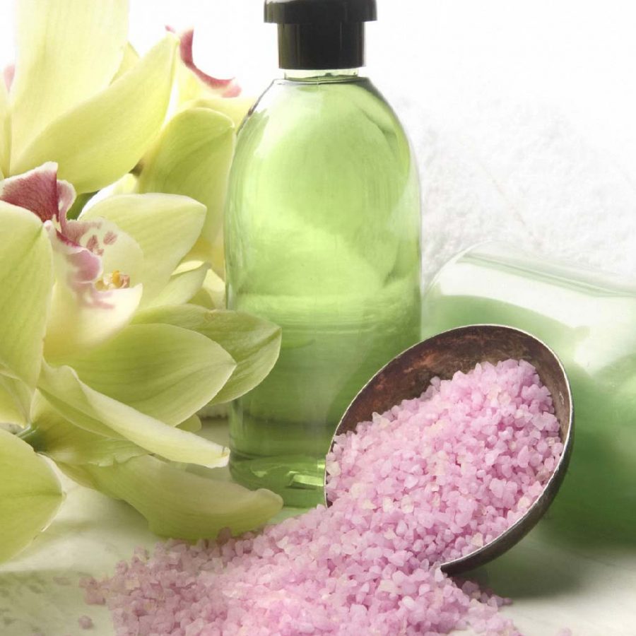 green bottle with yellow flowers and pink salt